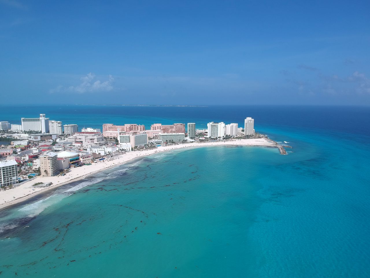 Discover the vibrant turquoise waters and pristine beaches of Cancun's iconic shoreline.